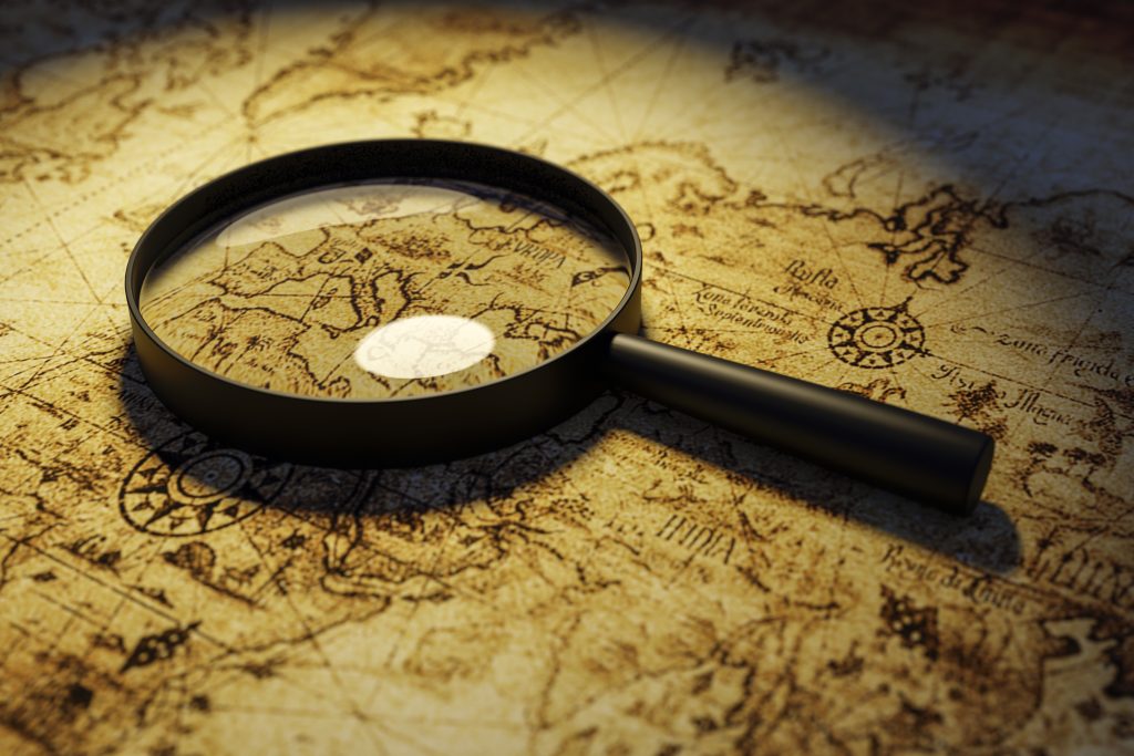 A magnifying glass lies on the table surface close-up.