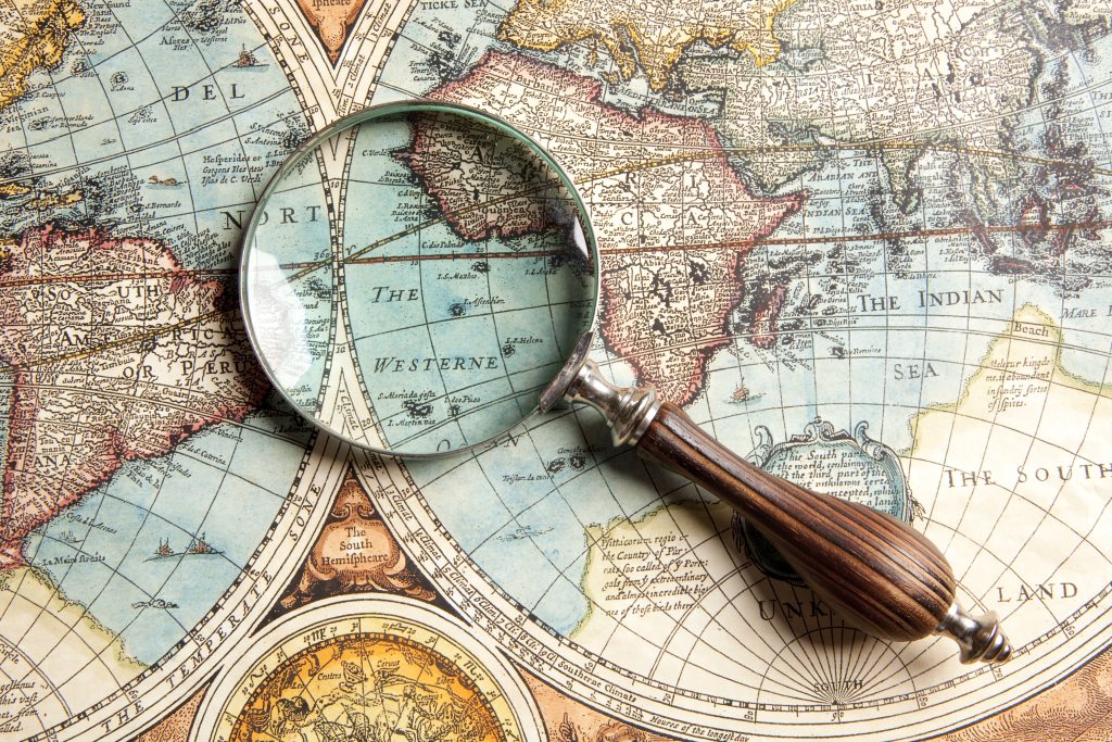 Magnifying glass and ancient old map